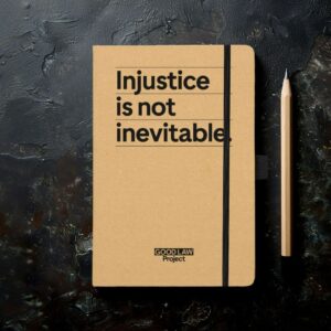 Notepad that says "Injustice is not inevitable"