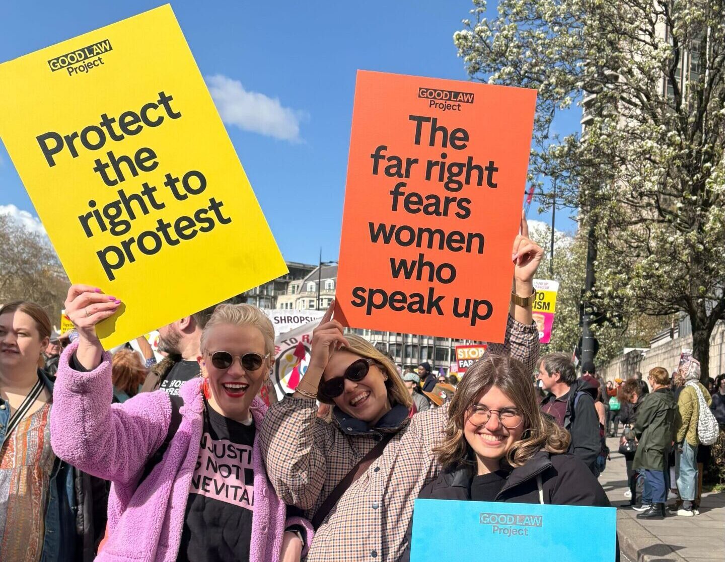 Good Law Project campaigners at protest holding posters